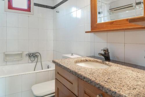 a bathroom with a sink and a toilet and a mirror at Villa Christina 2 in Mérikhas