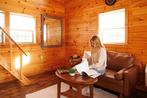 a woman sitting on a couch in a room at Presidential Mountain Resort in Bethlehem