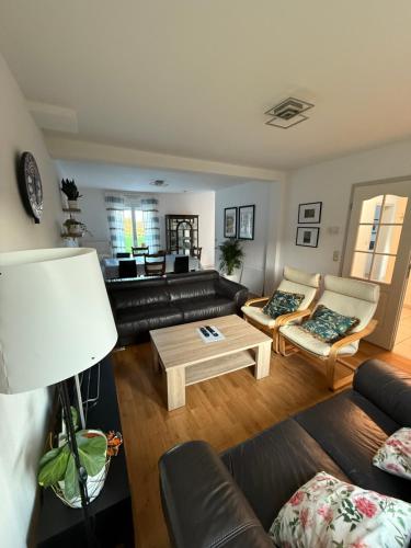 a living room with a couch and a coffee table at Zen House - Shopping at 3 min in Marnach
