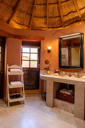 a bathroom with a sink and a mirror at Awasi Atacama in San Pedro de Atacama