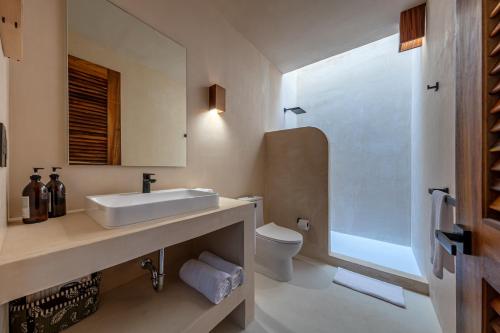 a bathroom with a sink and a toilet at Condominios Punta Morelos in Brisas de Zicatela