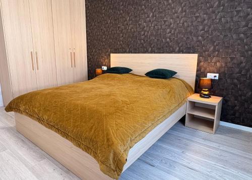 a bedroom with a bed with a brown comforter at home&stay - free parking in Trenčín