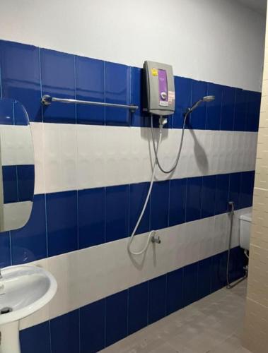 a bathroom with a blue and white tiled wall at Reggaein in Phi Phi Islands