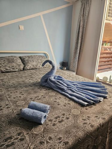a bedroom with a bed with a towel on it at Studio in the heart of Paphos in Paphos
