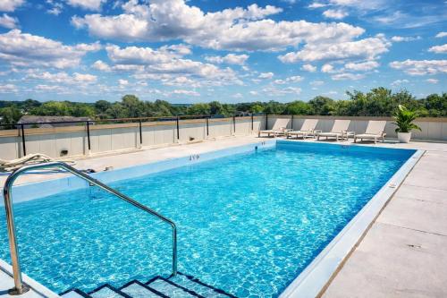 a swimming pool on the roof of a building at Luxury Rooftop Pool & Dock Steps to Downtown in Annapolis