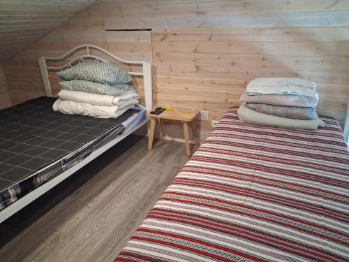 a bedroom with a bunk bed and a table with pillows at Kihulase maja in Luigu