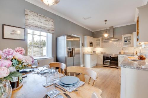 a kitchen and dining room with a table and chairs at 4 Bed in Bamburgh oc-gd1264 in Bamburgh