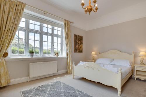 a bedroom with a white bed and a window at 4 Bed in Bamburgh oc-gd1264 in Bamburgh