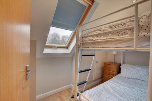 a bedroom with bunk beds and a window at 2 Bed in Little Petherick oc-p00635 in Little Petherick