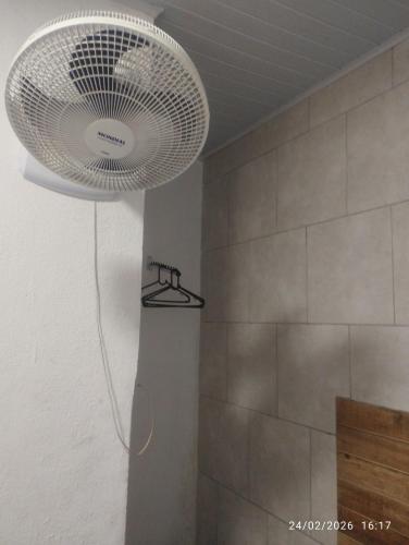 a bathroom with a shower with a large light fixture at Suíte 2 Itaguaí in Itaguaí