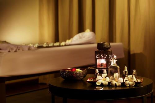 a room with a bed and a table with a table sidx sidx sidx at The Lake Garden Hotel Nay Pyi Taw - MGallery Collection in Nay Pyi Taw