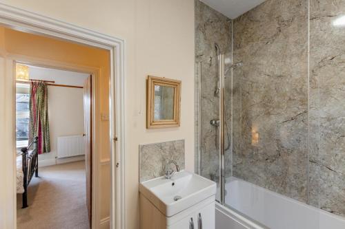 a white bathroom with a sink and a shower at 2 Bed in Ingleton oc-w31066 in Ingleton