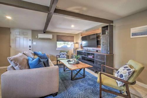 a living room with a couch and a table at Charming Lakefront Apt Near Disney in Orlando