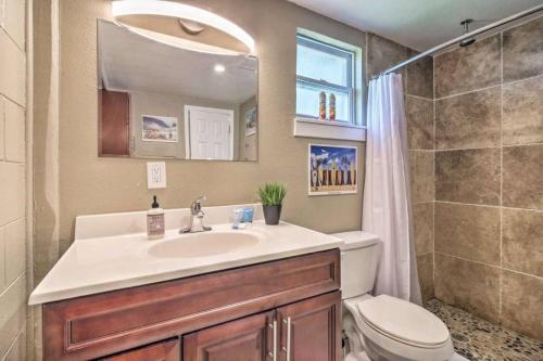 a bathroom with a sink and a toilet and a shower at Charming Lakefront Apt Near Disney in Orlando