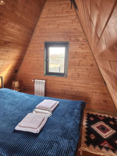 a bedroom with a bed in a wooden cabin at Day Off in Dushetʼi
