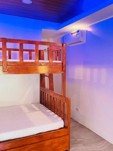 a bunk bed in a room with a blue ceiling at Skybloom Farm Resort in Balasic