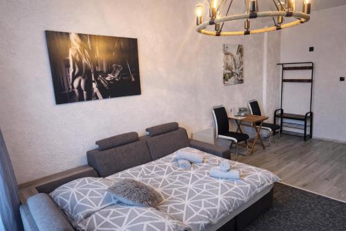 a bedroom with a bed and a table and chairs at Apartament Fantazja in Przemyśl