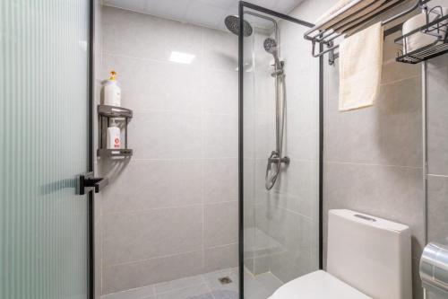 a shower stall in a bathroom with a toilet at Kikao-Marina Bay in Nairobi