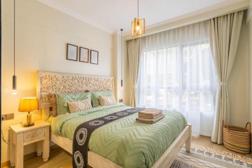 a bedroom with a large bed and a window at Kikao-Marina Bay in Nairobi