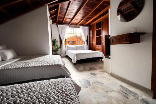 a bedroom with two beds and a large window at Tikki Lua in Cota