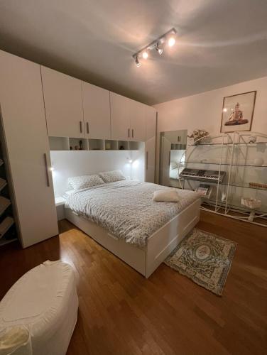 a bedroom with a bed and a glass cabinet at Casa Marisa in Monteviale