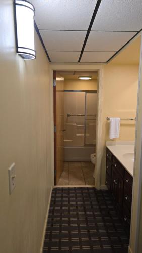 a bathroom with a shower and a sink and a toilet at Classic Inn Lancaster in Lancaster