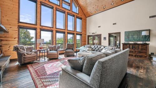 a living room with couches and chairs and windows at New Unbelievable Views Gourmet Kitchen Firepit in Broken Bow