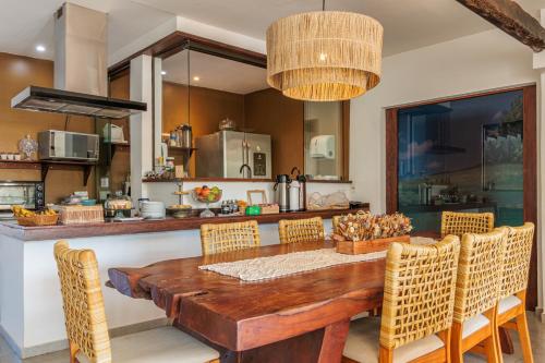 a kitchen with a wooden table and chairs at Casa Makaira in Fernando de Noronha