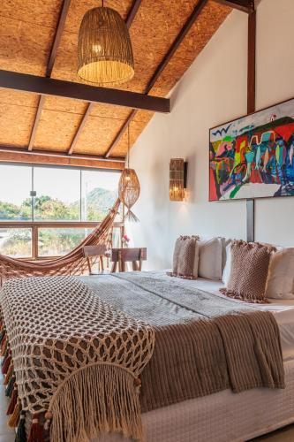 a bedroom with a bed and a large window at Casa Makaira in Fernando de Noronha