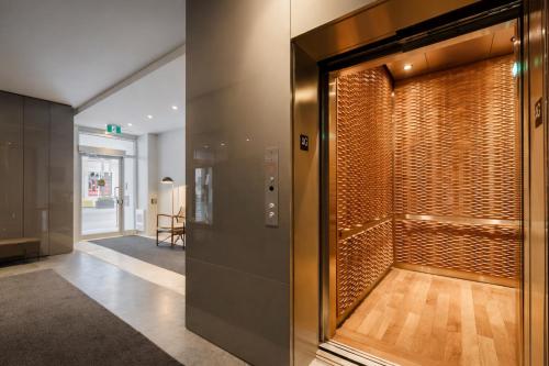 a hallway with a glass door to a room at Nester Finn Entertainment District in Toronto