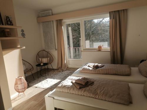 a bedroom with two beds and a window at Zeitinsel Doos in Waischenfeld