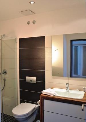 a bathroom with a toilet and a sink and a mirror at Reit- und Sporthotel Eibenstock in Eibenstock