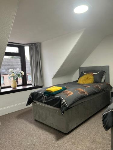 a bedroom with a large bed in a attic at Mortlach Cottage in Dufftown