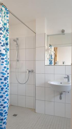 a bathroom with a shower and a sink at Südhotel in Paderborn