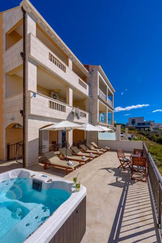 a building with a hot tub on a patio at Apartments Mrkan 2 in Cavtat