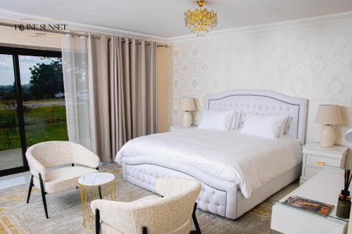 a bedroom with a white bed and a table and chairs at Olifile Boutique Hotel & Restaurant in Midrand