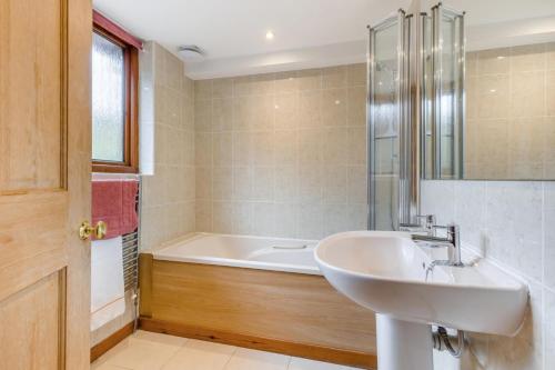 a bathroom with a sink and a bath tub at 2 Bed in Smallburgh oc-h33734 in Dilham
