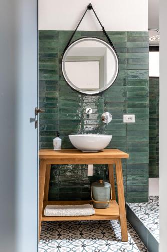 a bathroom with a sink and a mirror at Osterio Magno in Cefalù