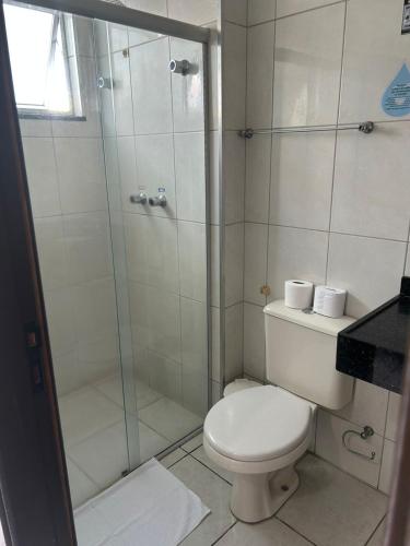 a bathroom with a toilet and a glass shower at Argentin Palace Hotel in Americana