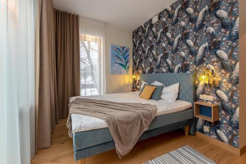 a bedroom with a bed with a large mural on the wall at Pargi 21 Apartments in Tartu