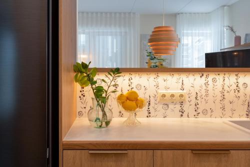 a counter with a vase of oranges in a kitchen at Pargi 21 Apartments in Tartu