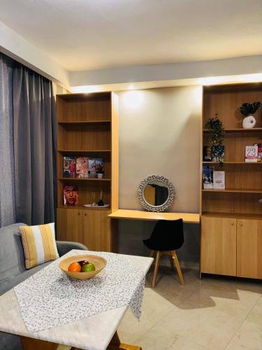 a living room with a table with a bowl of fruit on it at Downtown Studio 31 in Serres