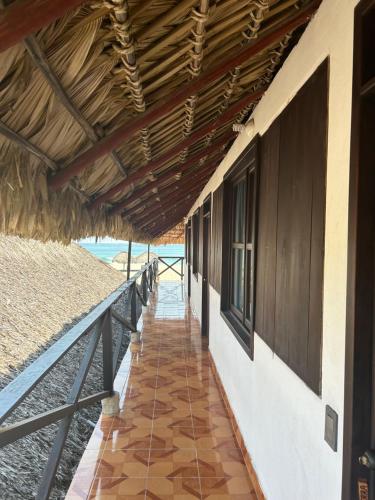 a walkway leading to a building with a roof at Terra Tipi in Guayabas