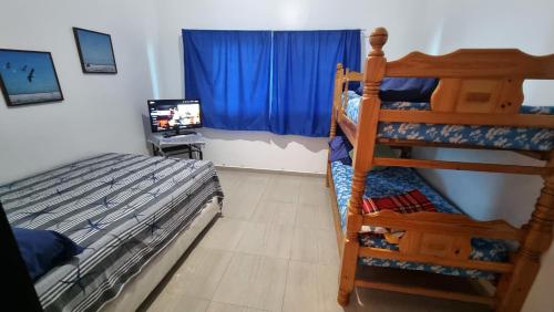 a bedroom with a bunk bed and a television at PREMIUM Puerto Varadero Apartamento con Vista al Mar y Planta Total in Tucacas
