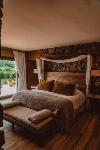 a bedroom with a large bed and a window at Awasi Mendoza in Ciudad Lujan de Cuyo