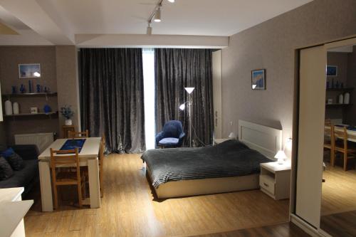 a bedroom with a bed and a desk and a room at Hotel Bobline 304 in Bakuriani