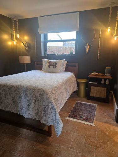 a bedroom with a large bed and a window at Casa Rosa Cheltenham - luxury unit, free parking - 5 star in Cheltenham