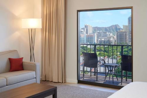 a hotel room with a view of a city at Aqua Palms Waikiki in Honolulu