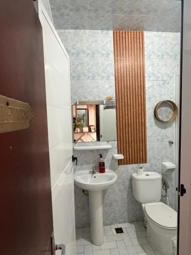 a small bathroom with a toilet and a sink at Dar Laila Surf in Tamraght Ouzdar