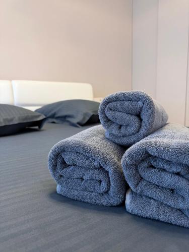 a pile of towels sitting on top of a bed at FLH - Obralix Home in Sibiu